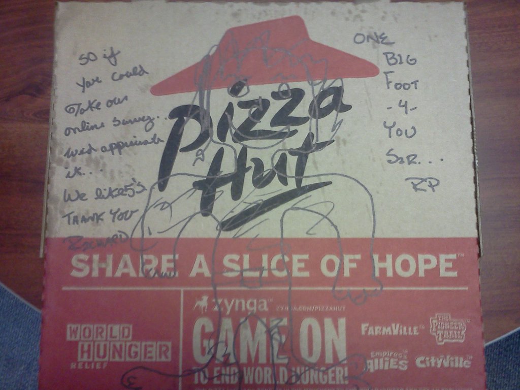 A Pizza Hut box with a bigfoot drawn on it and a request from the staff.