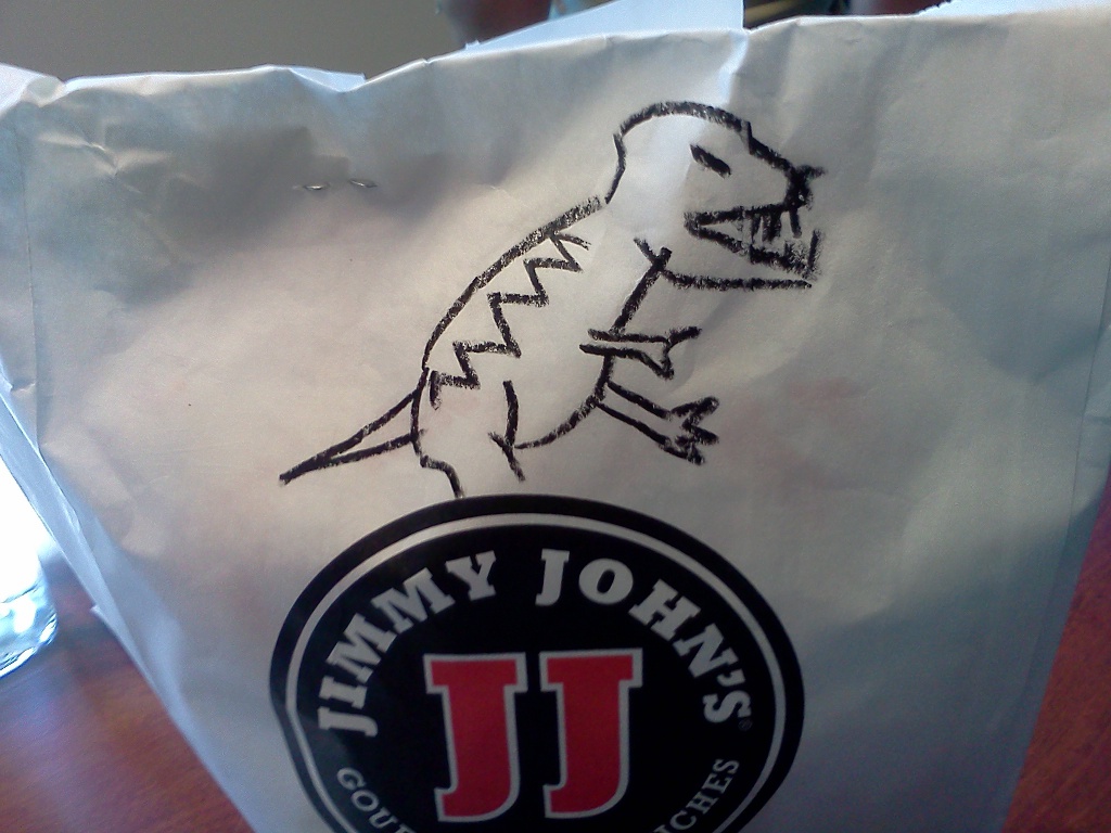Sandwich bag from Jimmy John's with a dinosaur drawn on it.